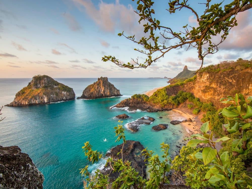 Coastal landscape with iconic pointed rock formations bathed by crystal clear, turquoise ocean waters. Coastal landscape with iconic pointed rock formations bathed by crystal clear, turquoise ocean waters.