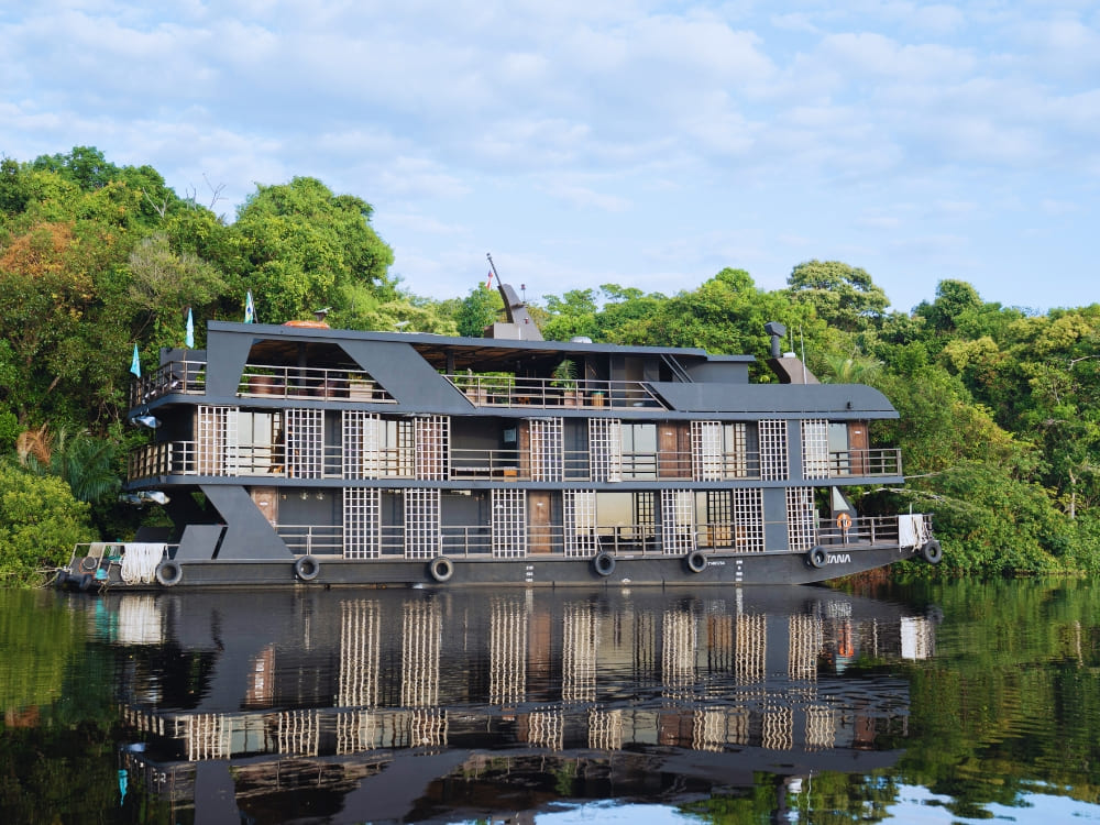 The Zaltana luxury riverboat floats calmly on the Rio Negro, offering high-end cruises through the Anavilhanas archipelago. The Zaltana luxury riverboat floats calmly on the Rio Negro, offering high-end cruises through the Anavilhanas archipelago.