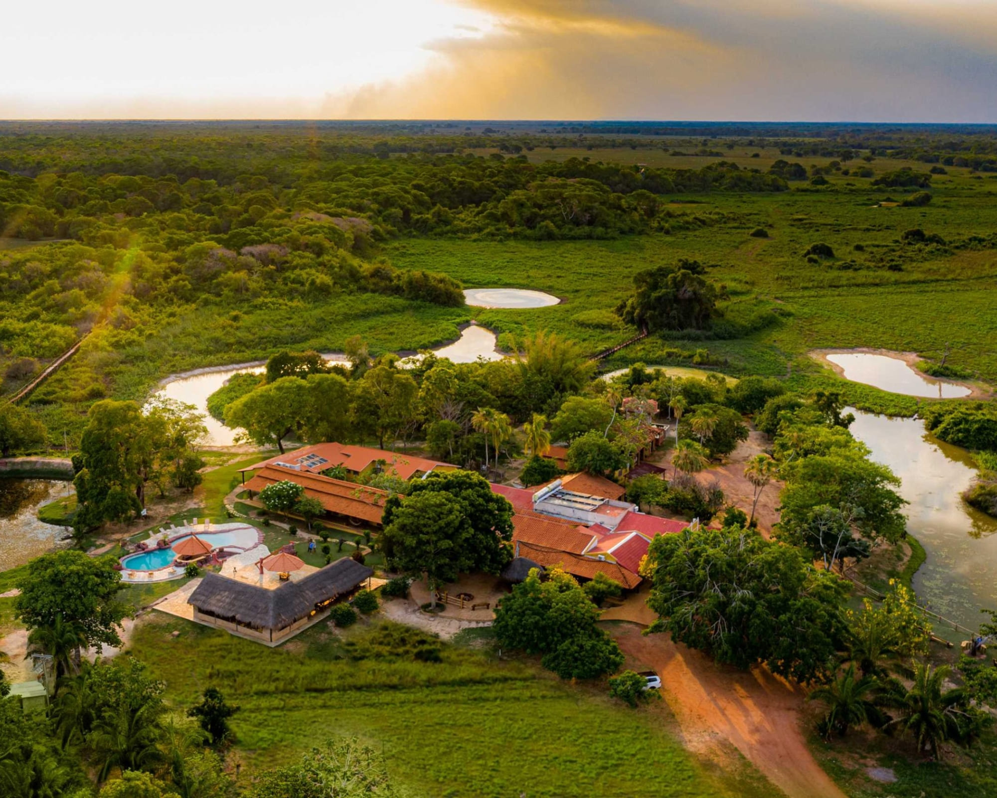 Aerial view of Araras Lodge showing the swimming pool and eco-friendly infrastructure surrounded by the Pantanal ecosystem Aerial view of Araras Lodge showing the swimming pool and eco-friendly infrastructure surrounded by the Pantanal ecosystem