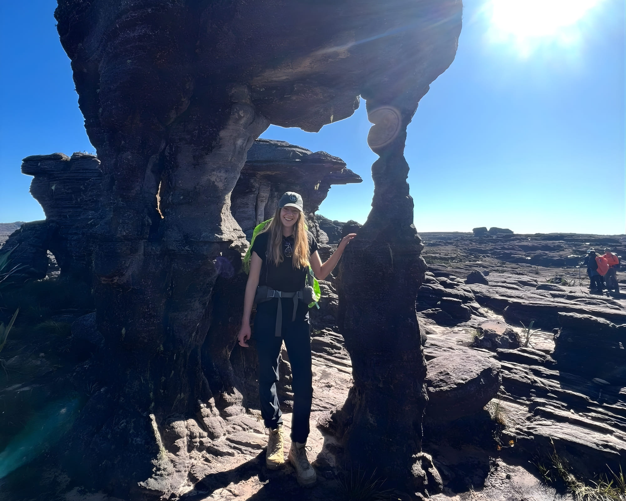 Solo traveler Olivia Bird stands between ancient rock formations during her Mount Roraima trek in Brazil.