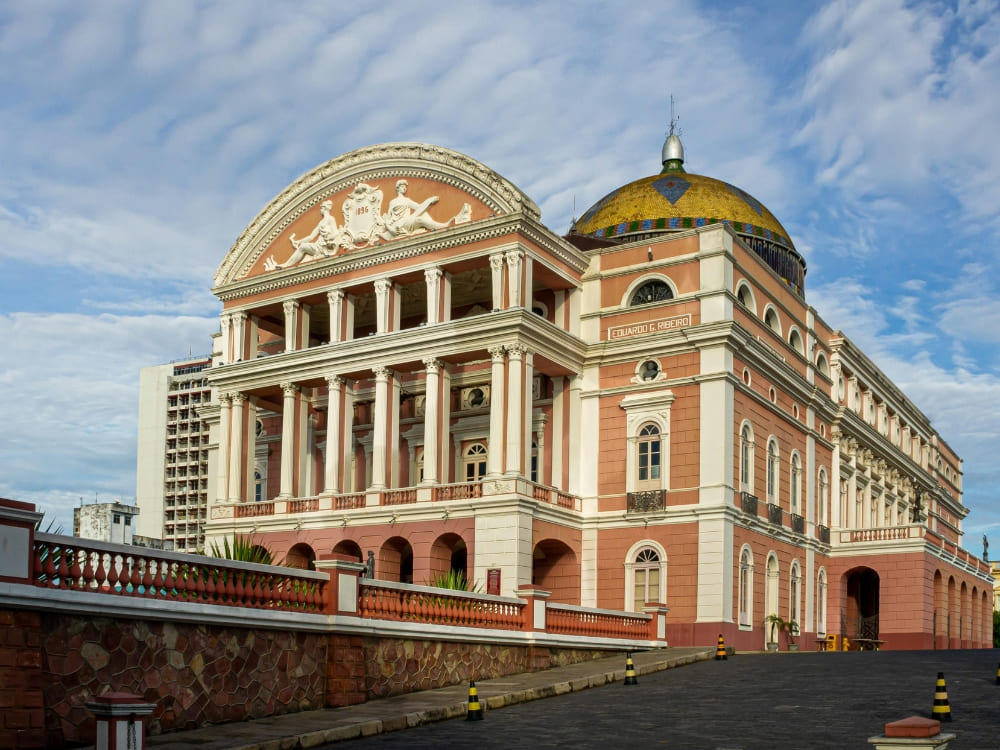 The Teatro Amazonas opera house featuring a colorful dome and pink facade in the Centro Histórico of Manaus. The Teatro Amazonas opera house featuring a colorful dome and pink facade in the Centro Histórico of Manaus.